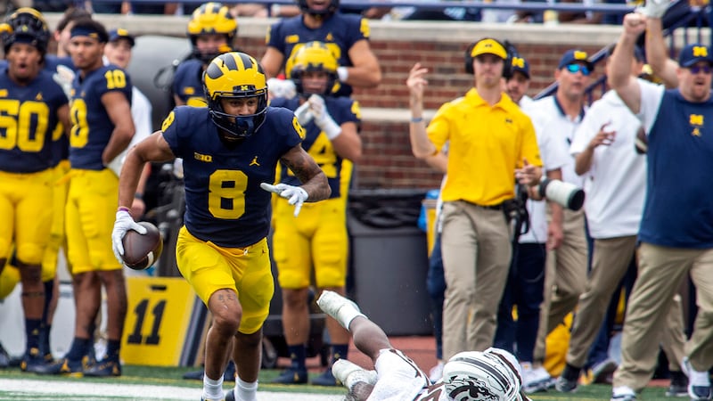 Michigan wide receiver Ronnie Bell (8) beats Western Michigan safety Delano Ware (26) to a...