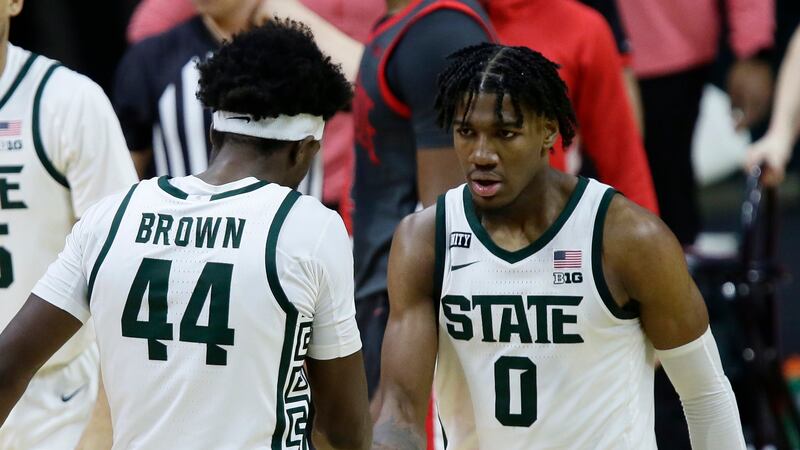 Michigan State forward Aaron Henry (0) celebrates with forward Gabe Brown (44) after scoring...