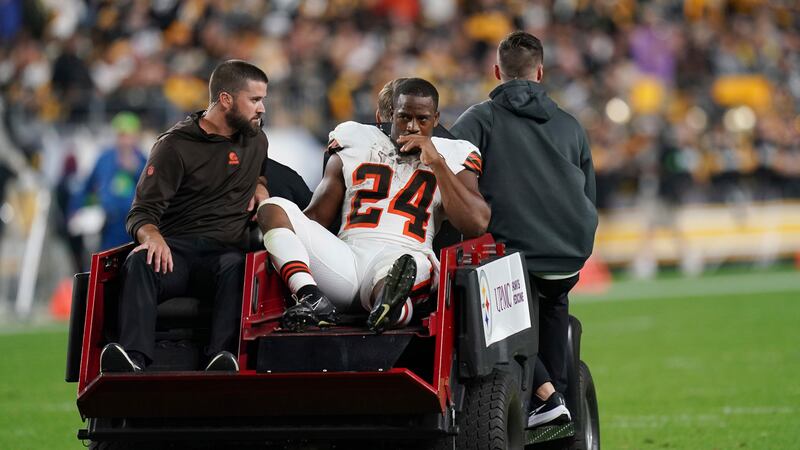 Cleveland Browns running back Nick Chubb is cared off the field with an injury during the...