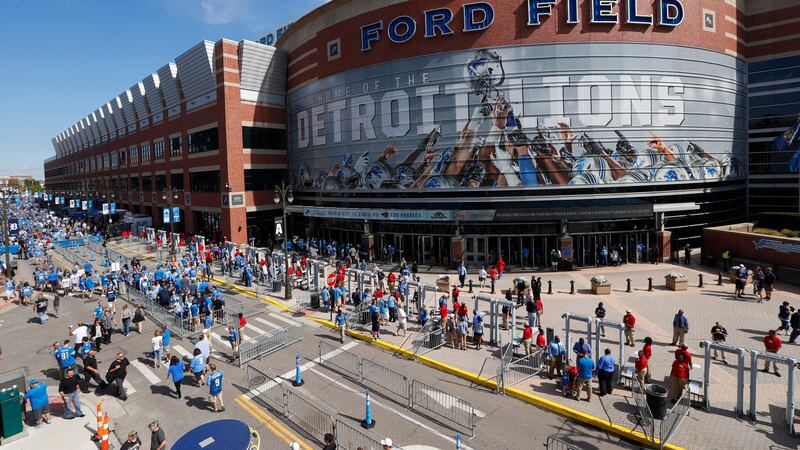 FILE - In this Sept. 18, 2016, file photo, football fans arrive at Ford Field for an NFL...