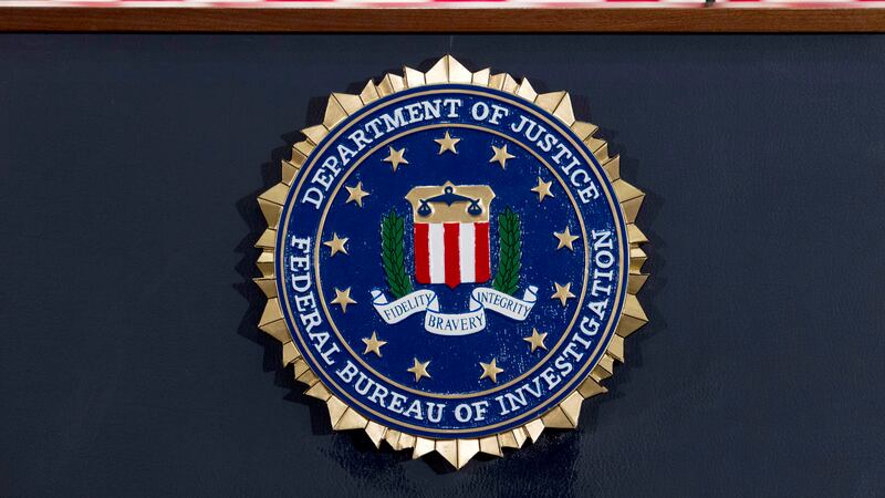 FILE - The FBI seal is displayed on a podium before a news conference at the agency's...