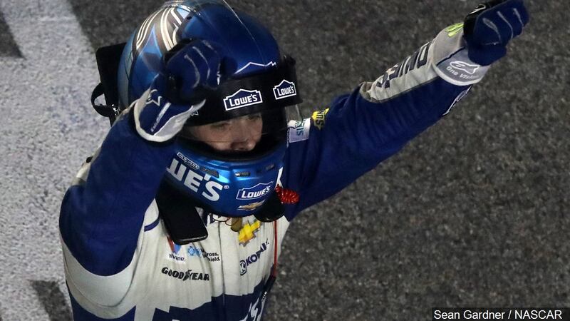 NASCAR driver Jimmie Johnson wears a HANS device after emerging from his car following a...