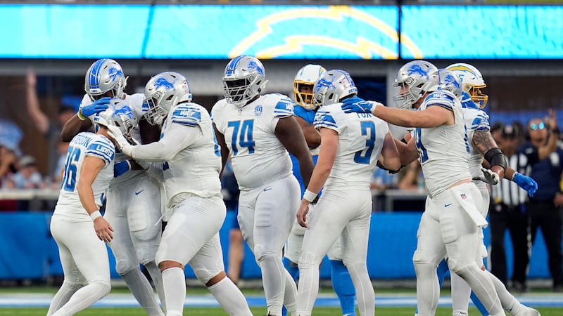 Detroit Lions place kicker Riley Patterson, left, celebrates with teammates after making the...