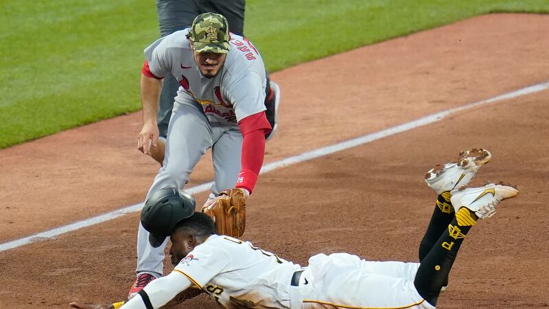 St. Louis Cardinals third baseman Nolan Arenado, top front, tags out Pittsburgh Pirates'...
