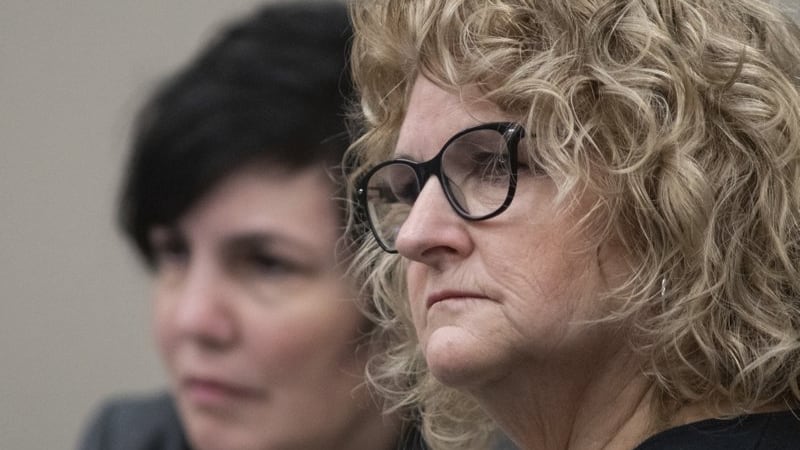 Former Michigan State University women's gymnastics coach Kathie Klages listens to...