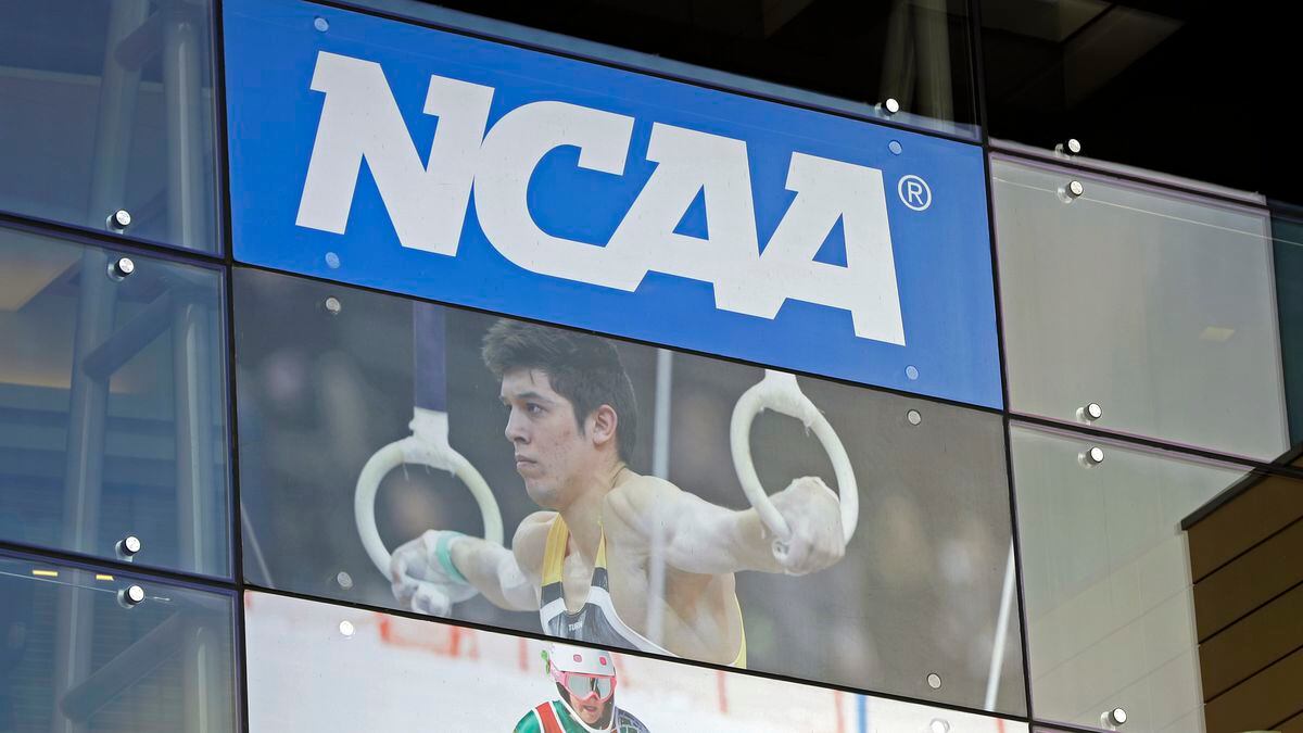 In this April 25, 2018, file photo, the NCAA headquarters is shown in Indianapolis. The NCAA is expected to approve a recommendation to all athletes who compete in fall sports, including football, over the next 10 months to not be charged a year of eligibility. It's great news for current players, but comes with some complications for teams, coaches and future college football players.